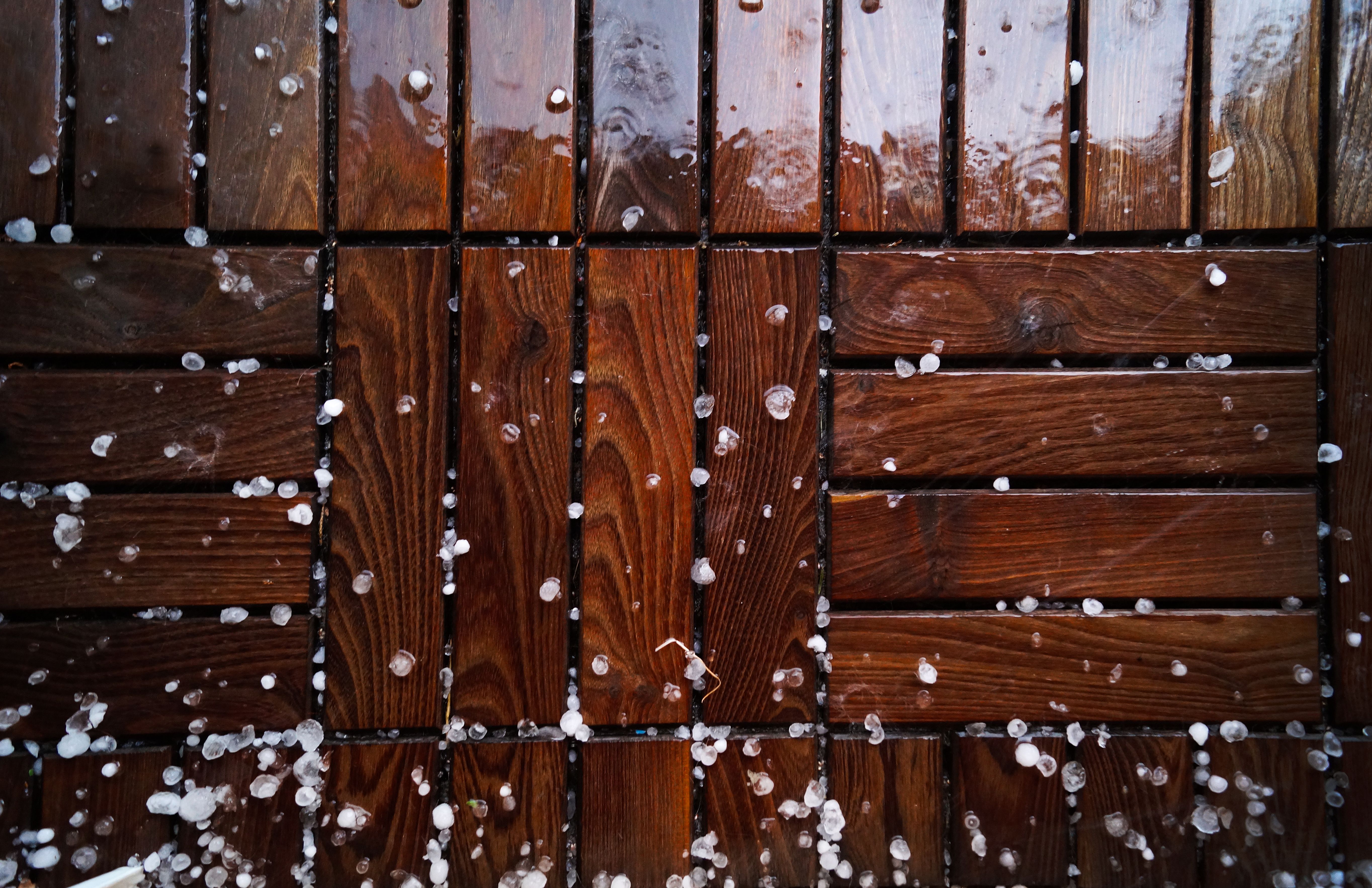 Close-up of a wet wooden deck surface with natural grain texture